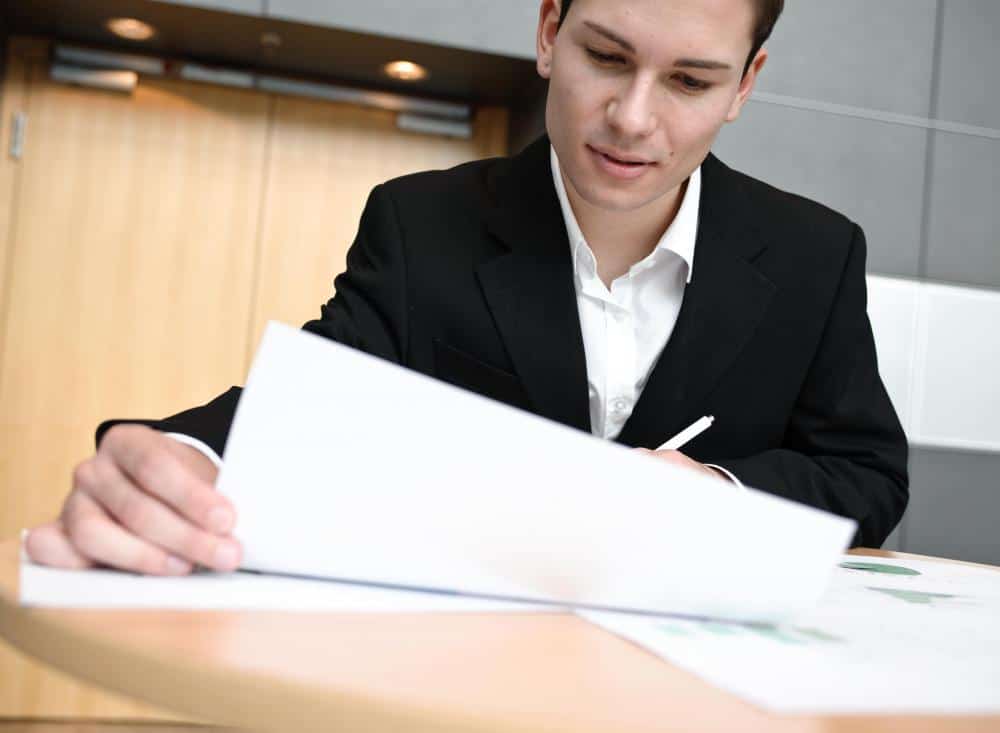 man in suit looking at paper 2
