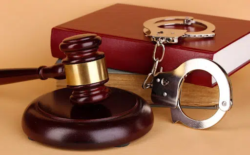 Gavel, Handcuffs Andbook On Law On Beige Background