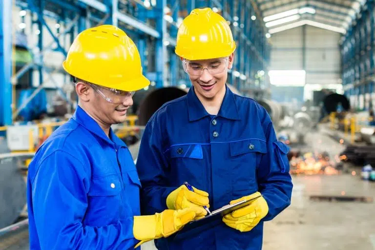 Two Workers In Production Plant As Team