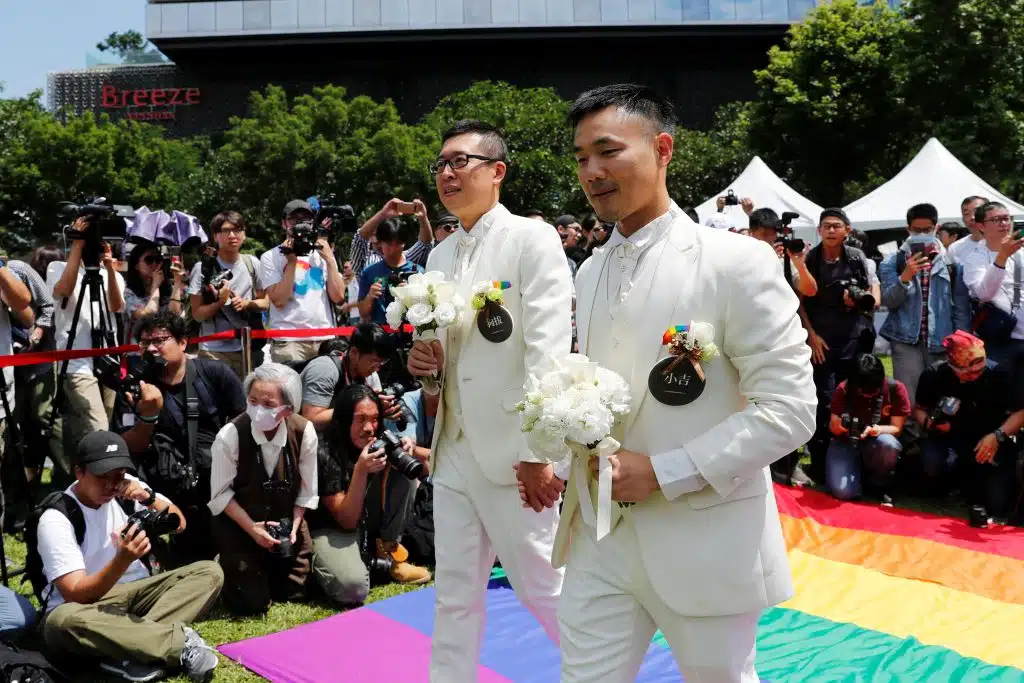 Gay Newlyweds Walk On A Giant Rainbow Flag At A Pro Same Sex Marriage Party After Registering Their Marriage In Taipei